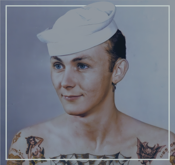A colorized picture of a sailor with tattoos.